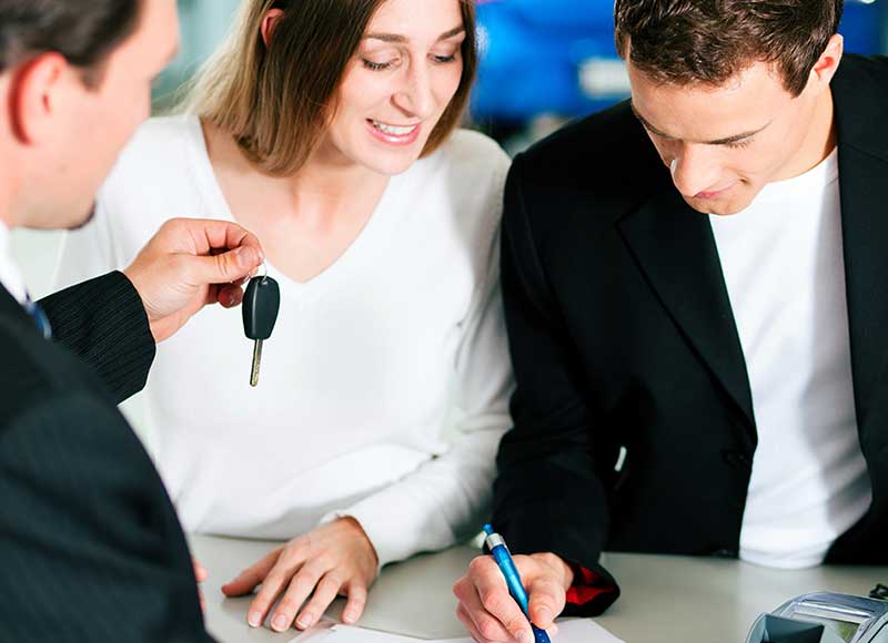 Image of a couple purchasing a car