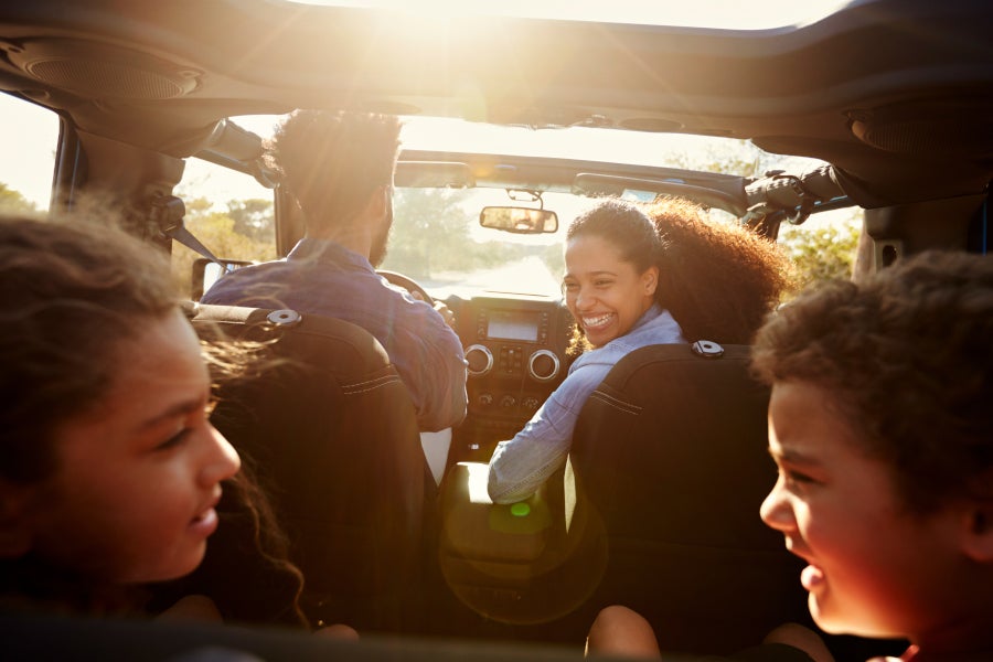 A family smiling in a car